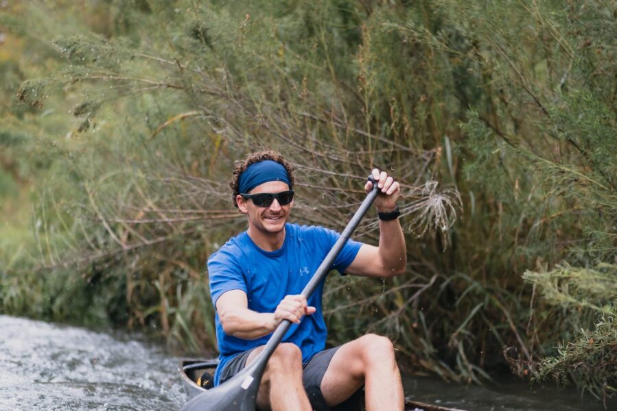 Spencer Fuller training in a racing canoe on a Texas river.